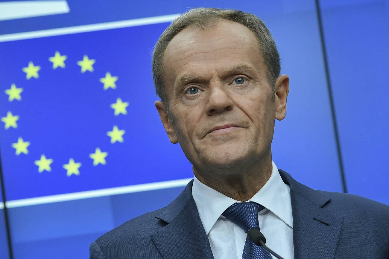 Donald Tusk na tle flagi Unii Europejskiej