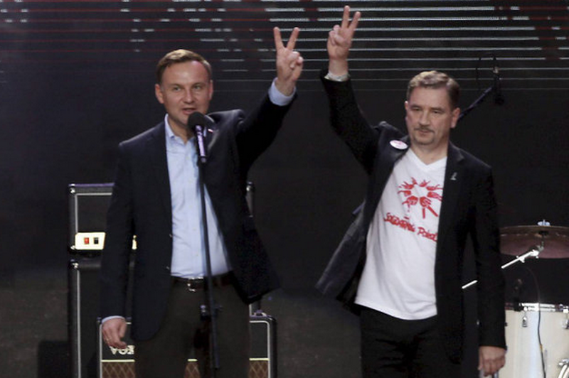 Prezydent Duda razem z szefem "Solidarności" Piotrem Dudą podczas koncerty na 35-lecie powstania związków zawodowych.