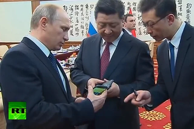 Władimir Putin pokazuje YotaPhone'a prezydentowi Chin  Xi Jinpingowi (w środku)
