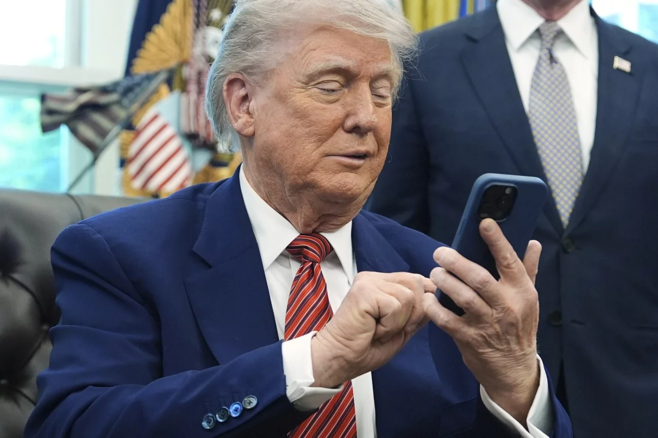 Prezydent USA Donald Trump ogłasza 50 proc. cła na Unię Europejską. To wojna handlowa. Wiadomo, od kiedy cła zaczną obowiązywać. Donald Trump w gabinecie owalnym korzystający z telefonu komórkowego.
