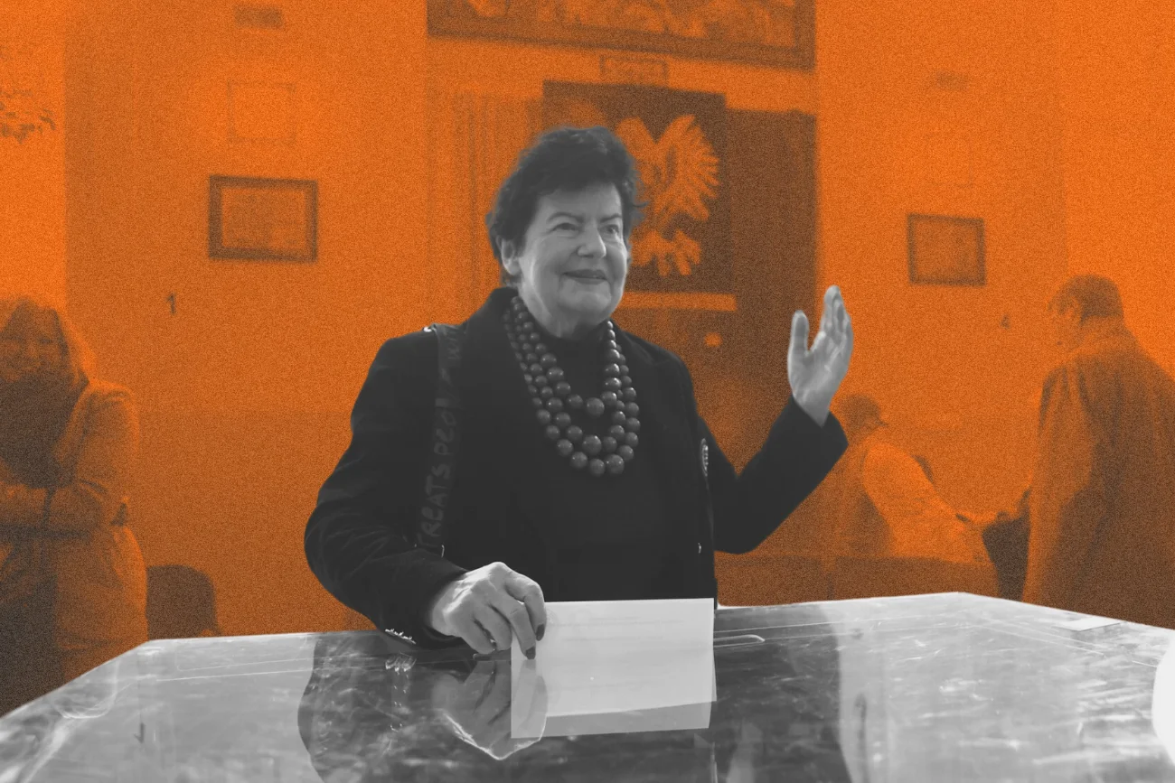 Joanna Senyszyn z uśmiechem na twarzy wrzuca kartę wyborczą do urny. Drugą rękę ma podniesioną w geście pozdrowienia. Polityczka w głosowaniu 1 czerwca popiera Rafała Trzaskowskiego.