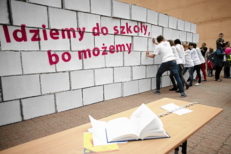 Dzieci z autyzmem burzą symboliczny mur, który utrudnia im pójście do szkoły. Ten happening zorganizowano w 2013 r. w Łodzi.