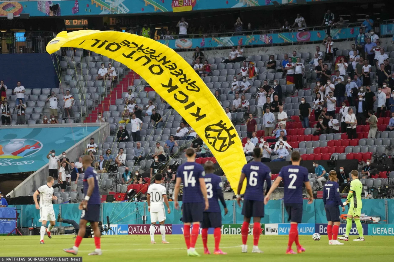 Paralotniarz, który wylądował na murawie Allianz Areny miał na skrzydle napis "Kick out oil!"