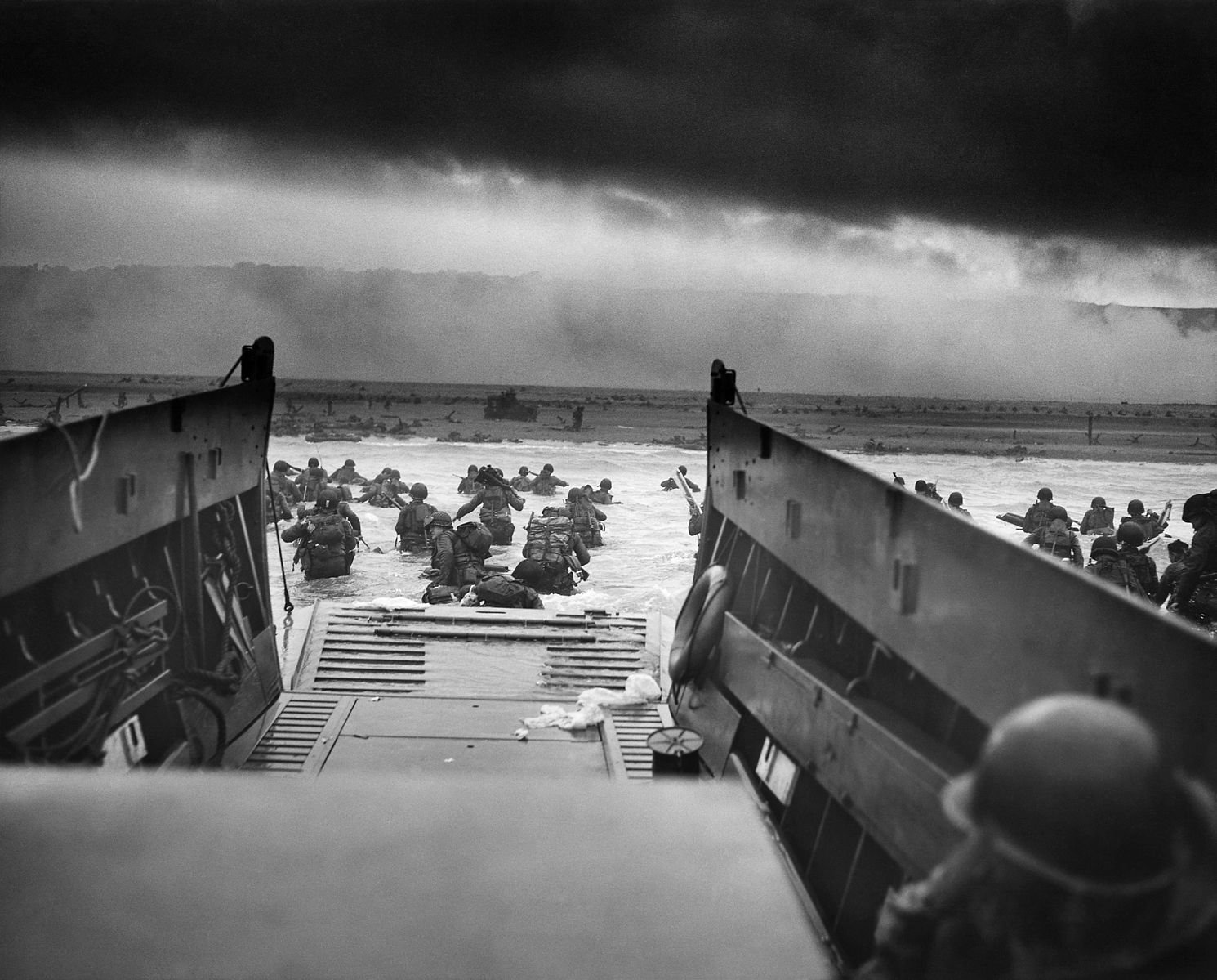 "Into the Jaws of Death — U.S. Troops wading through water and Nazi gunfire"