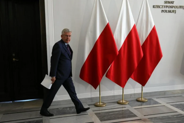 Były marszałek Senatu Stanisław Karczewski (PiS) na tle wyłącznie polskich flag.