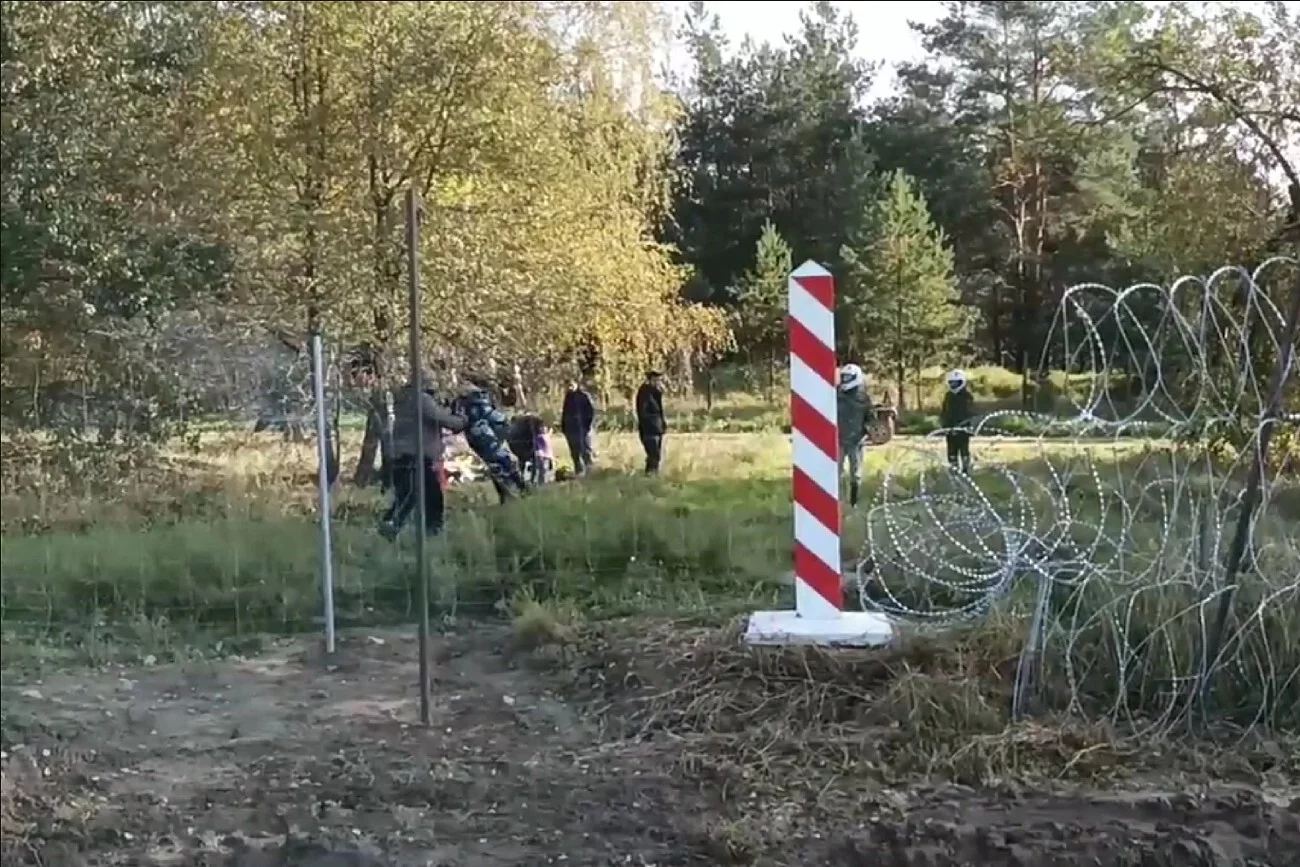 MON pokazało na Twitterze krótki film, na którym "widać jak migrant wraz z dzieckiem pozuje do zdjęcia wykonując polecenia białoruskiego żołnierza".