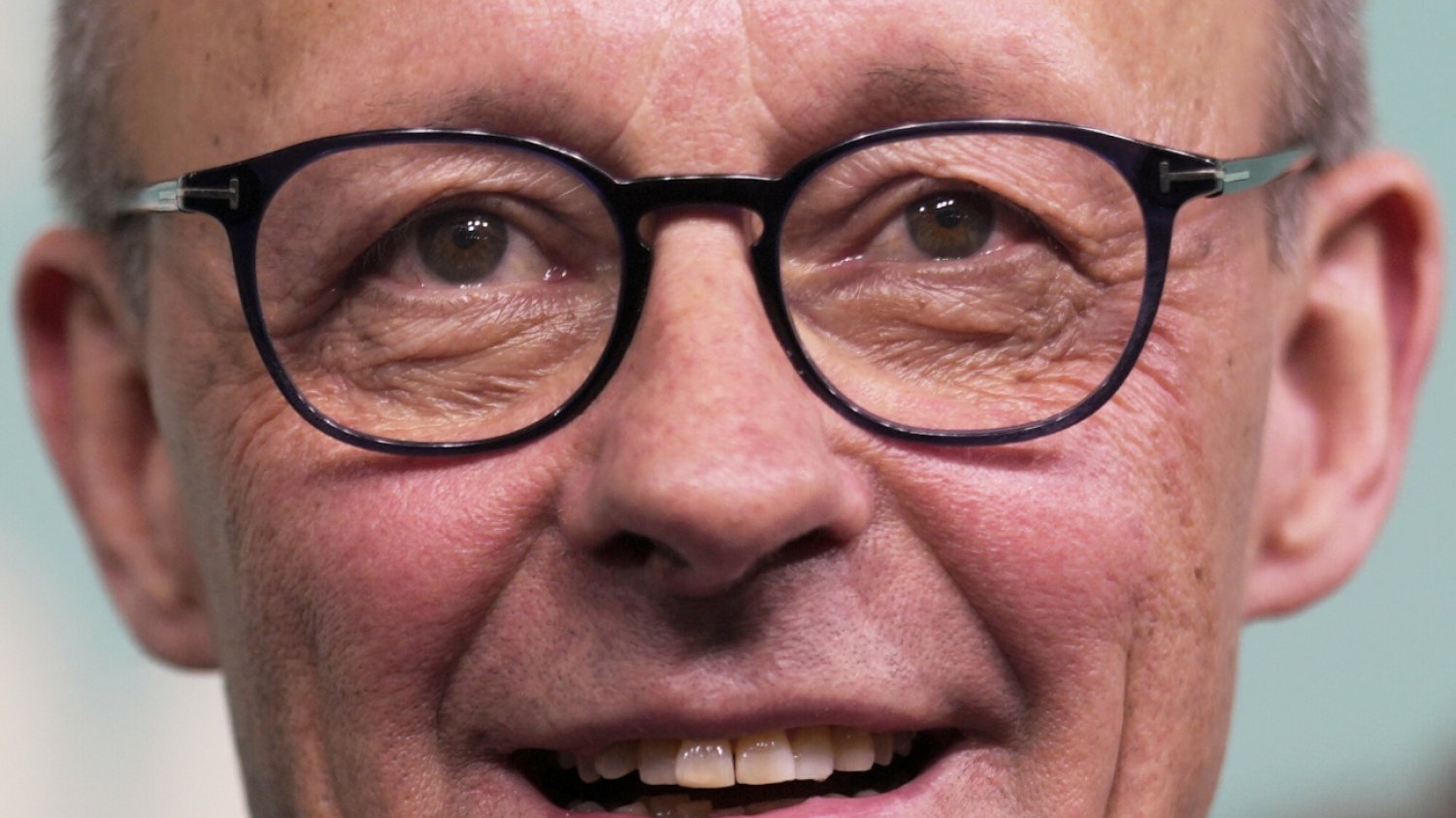 Friedrich Merz to prawdopodobnie nowy kanclerz Niemiec. Na to wskazują wyniki wyborów do Bundestagu. Friedrich Merz: jego uśmiechnięta twarz w okularach.