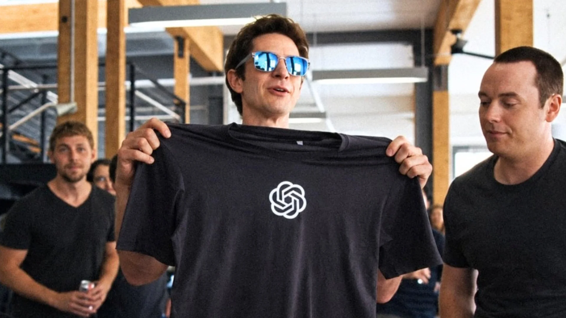 Andrew Garfield jako Sam Altman trzyma koszulkę z logo ChatGPT
