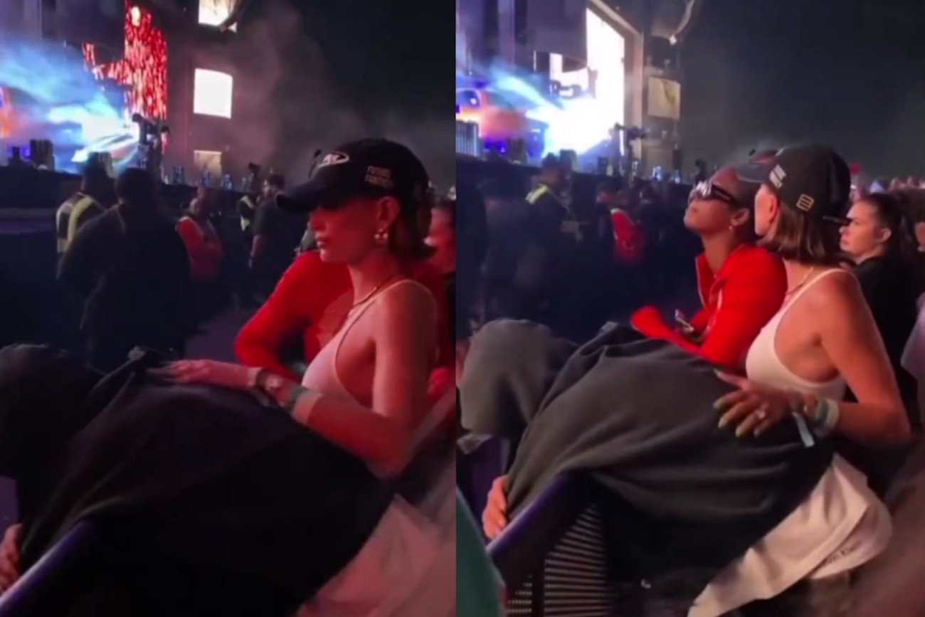 Justin Bieber opiera się o barierki, a Hailey głaszcze go po plecach.