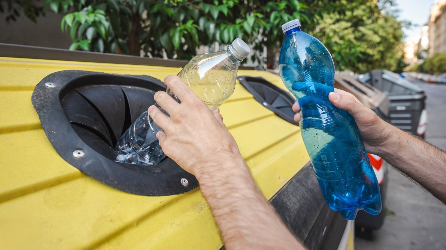 Kradzież butelek z kaucją w Polsce w 2026 roku Mężczyzna wyciąga butelki zwrotne z kontenera, kradzież kaucji, recykling.