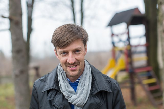 Zdzisław Zwoliński na tle placu zabaw, który wybudował wspólnie z rodzicami.