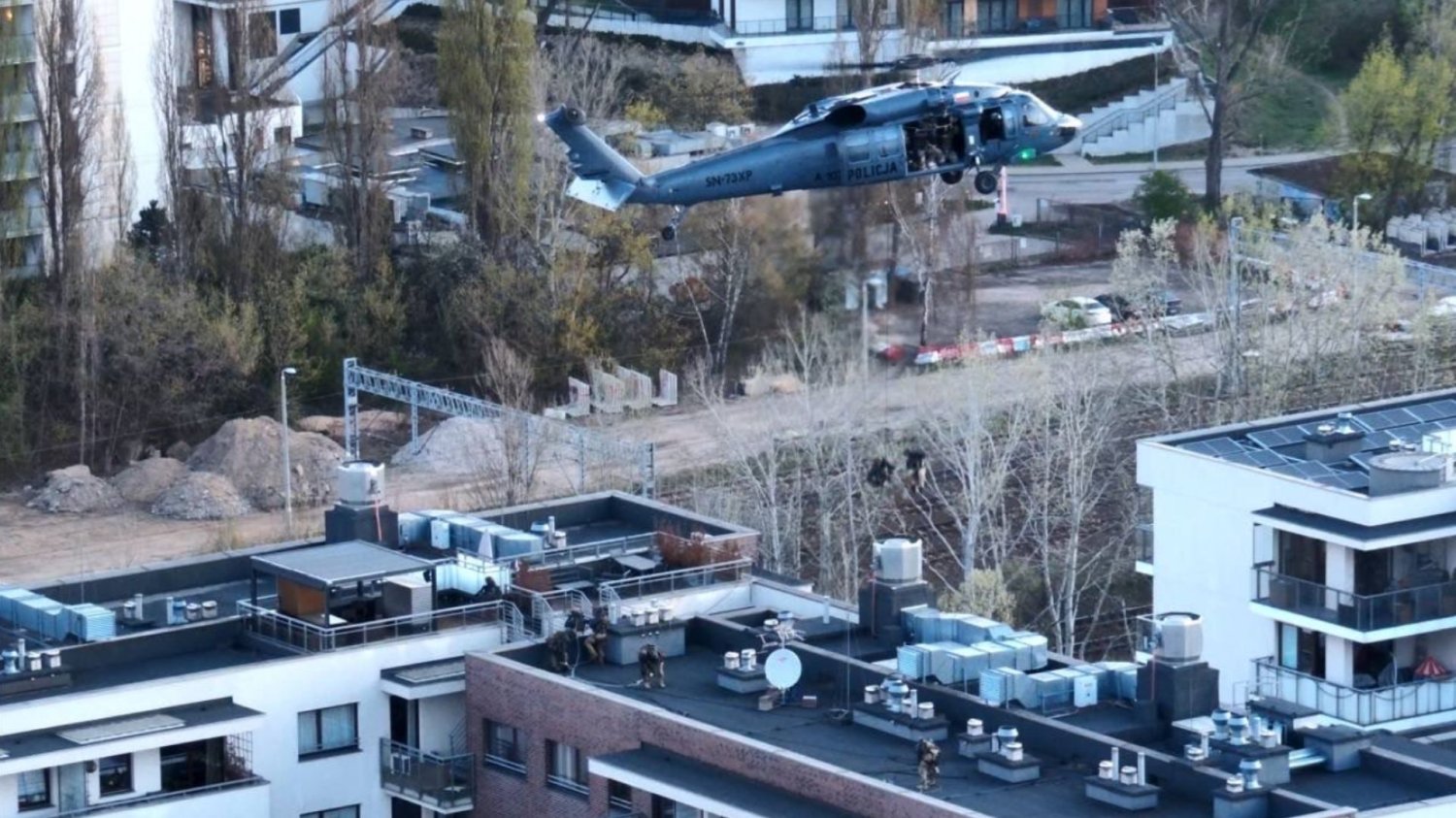 Śmigłowiec Black Hawk nad dachem budynku.