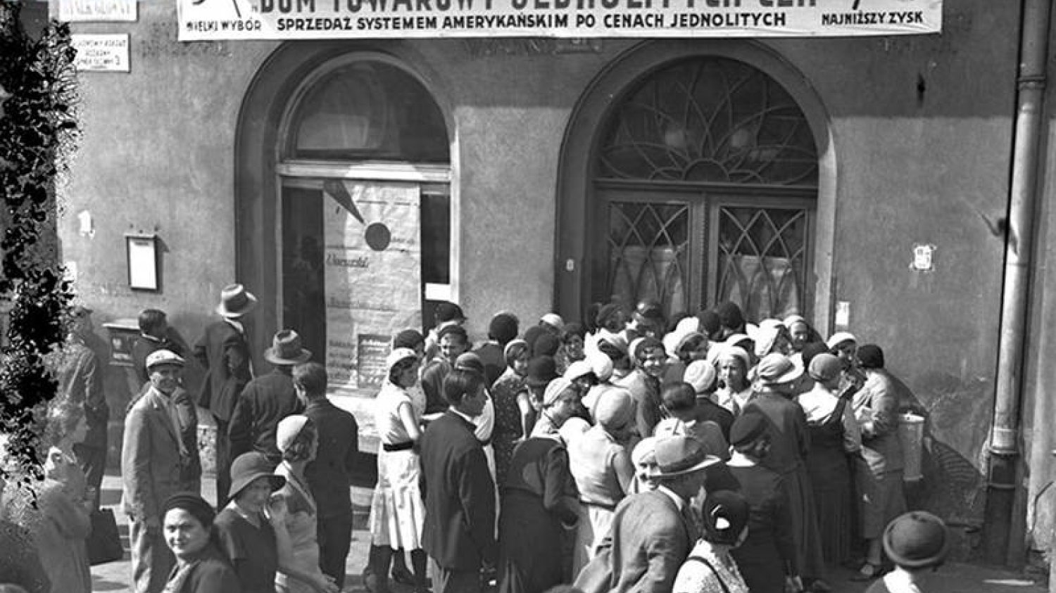 Kolejka do domu towarowego jednolitych cen w Warszawie. To jedno z wielu zdjęć przedstawiających handel w II Rzeczpospolitej