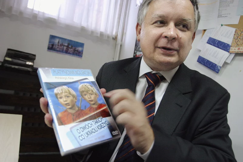 Lech Kaczyński z wydanym na płycie filmem "O dwóch takich, co ukradli księżyc". Zdjęcie z 2005 r.