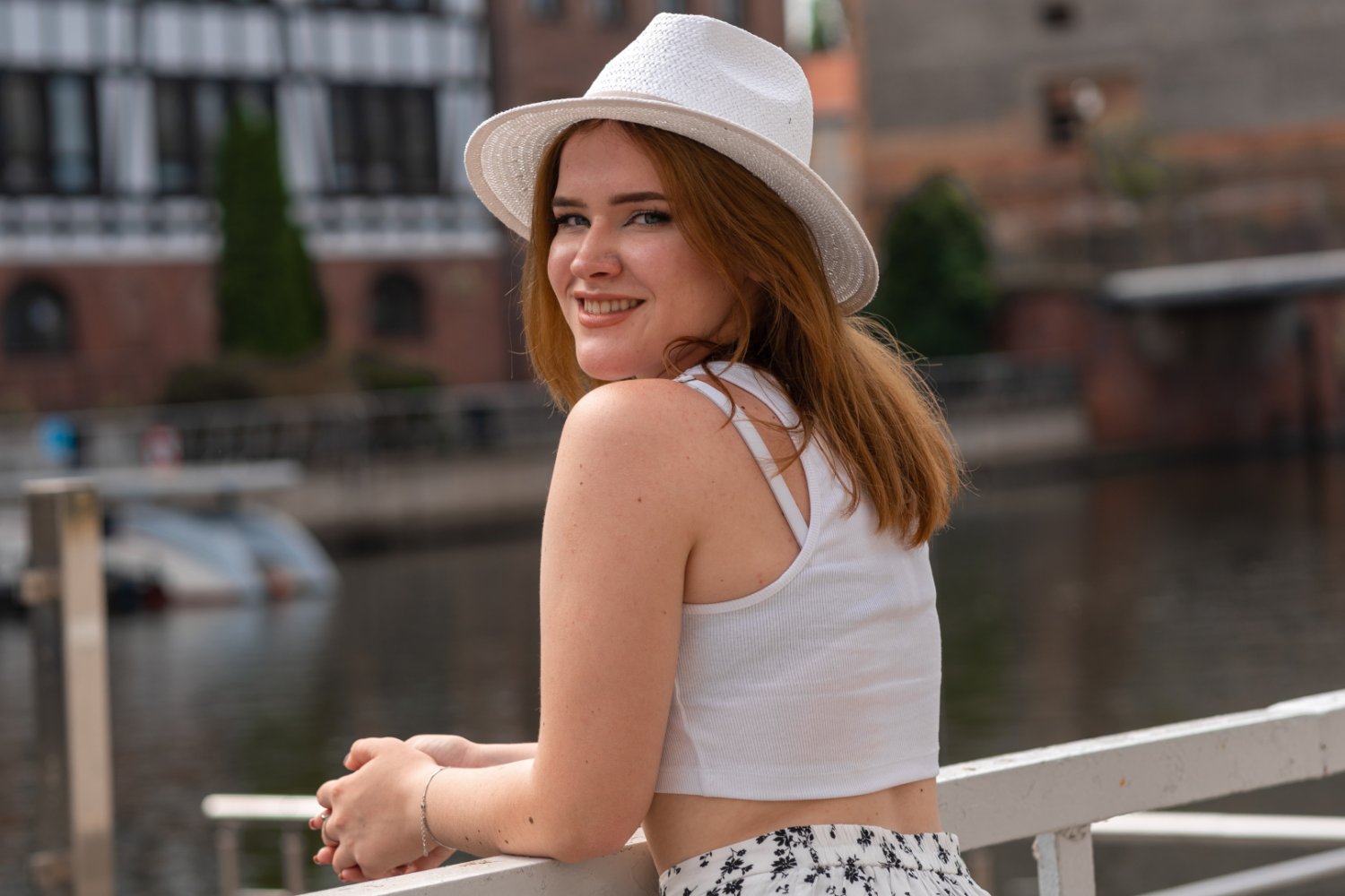 Dziewczyna w białym kapeluszu na tle miasta Gdańsk