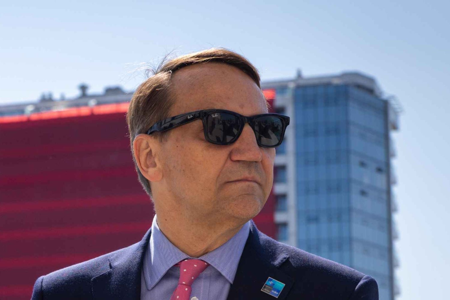 Sikorski wystawił prawicy rachunek za pobicie Ślązaka. Tylko 1 pytanie z Kijowa Radosław Sikorski w okularach przeciwsłonecznych na tle czerwonego budynku