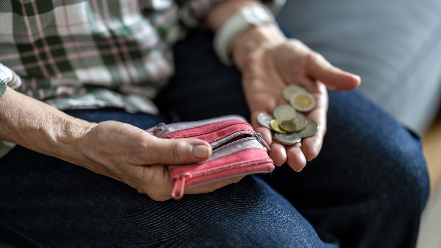 Starszy mężczyzna liczy pieniądze z portfela. Prognozowana waloryzacja emerytur 2027.