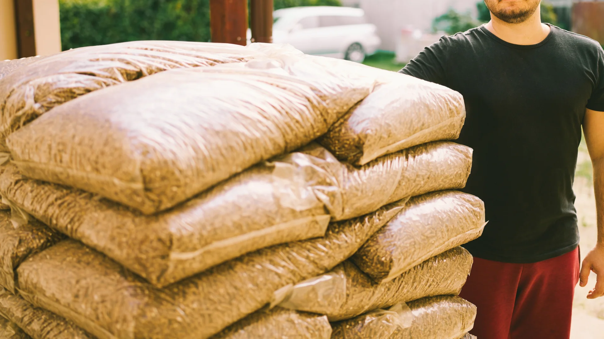 Ceny opału w sierpniu 2026: węgiel, pellet, agropellet idą w górę Worki z pelletem drzewnym na podwórku latem